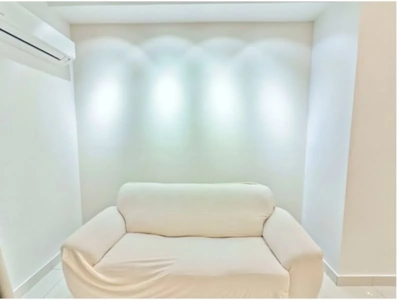 Room features: white walls, recessed lighting, white sofa, tile flooring, wall-mounted split AC; style: modern.