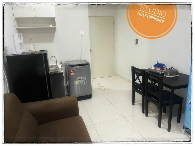 Room features: brown fabric sofa, white painted walls, white tiled flooring, black refrigerator, silver washing machine, single-bowl stainless-steel sink, chrome pull-down faucet, black dining table with four chairs, kitchen cabinets above sink, microwave, power outlet on wall; style: modern.