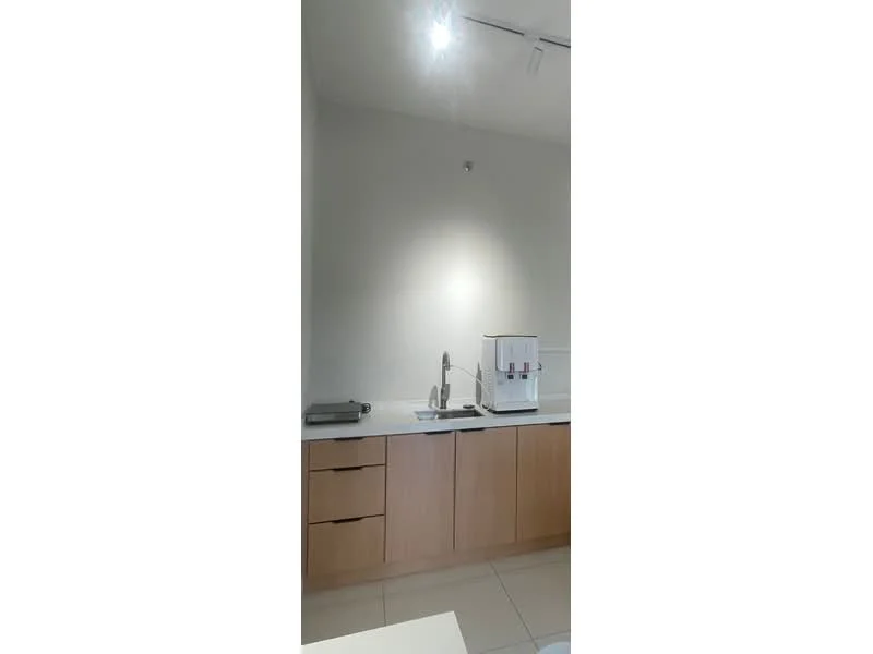 Kitchen features: light wood cabinetry, white countertop, stainless-steel sink, chrome pull-down faucet, built-in water dispenser, recessed LED downlights, cream tiled flooring, plain white walls; style: modern.