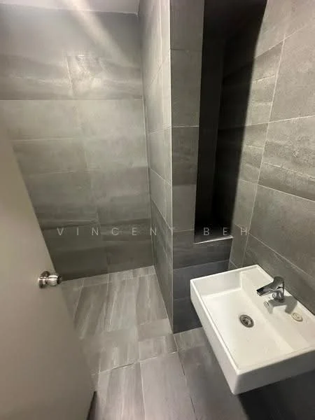 Bathroom features: grey tile flooring, grey wall tiles, wall-mounted sink, chrome faucet, shower area with tiled walls, no visible shower fixtures, minimalist design, corner shower space; style: modern.