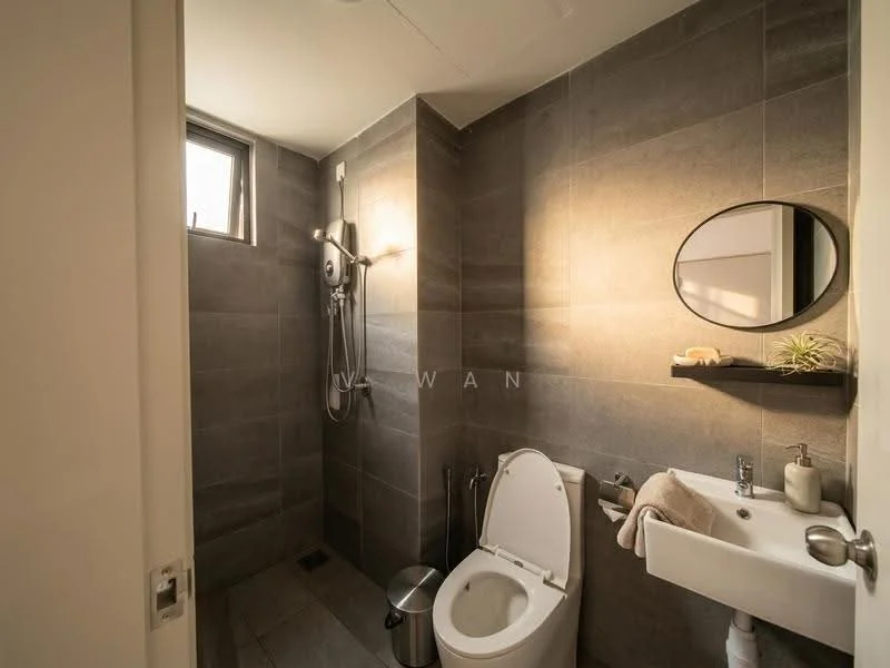 Bathroom features: grey tile flooring, grey tile walls, walk-in shower with glass enclosure, rain shower head, handheld shower, round mirror, white wall-mounted sink, one-piece toilet, towel rack, small plant decor, shower control panel, window for natural light; style: modern.