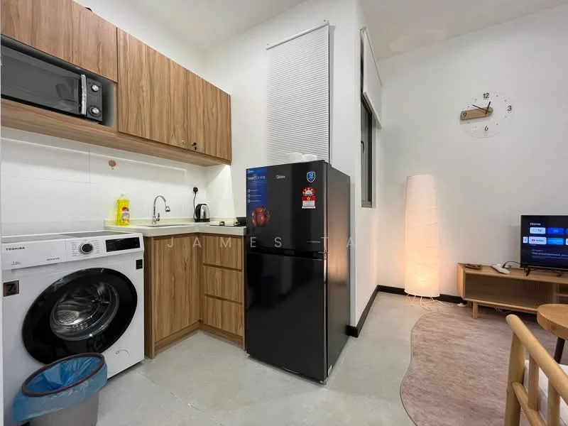 Kitchen features: wood cabinetry, black refrigerator, built-in microwave, single-bowl stainless-steel sink, chrome pull-down faucet, washing machine, countertop, wall-mounted clock, flooring with grey tiles, table lamp, TV console, sofa, area rug; style: modern.