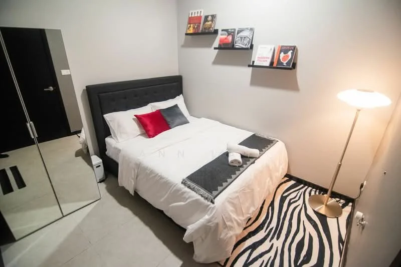 Bedroom features: queen-size bed with grey upholstered headboard, white bedding with decorative red pillow, black bedside table, floor lamp with white shade, mirrored wardrobe, zebra-pattern area rug, grey painted walls, shelves with books and decor; style: modern.