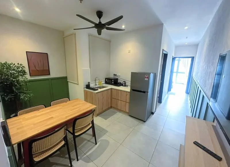 Kitchen features: light wood dining table with 4 chairs, green accent wall, white painted walls, grey tile flooring, ceiling fan, stainless-steel fridge, microwave, countertop with sink, kitchen cabinetry, window with natural light; style: modern.