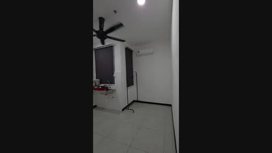 Room features: white painted walls, ceiling fan, wall-mounted split AC, tile flooring, black trim around windows, window with roller blinds, light fixture on ceiling, sink with countertop.