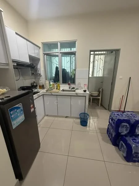 Kitchen features: white cabinetry, stainless-steel fridge, single-bowl stainless-steel sink, chrome pull-down faucet, ceramic tile flooring, white tiled backsplash, countertop with space for appliances, window with metal grille, light-colored walls, plastic chair, water bottles stacked, cleaning supplies visible; style: modern.