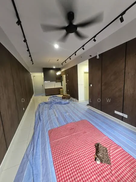 Room features: wood panelled walls, white painted ceiling, recessed LED downlights, ceiling fan, tile flooring, blue and red checkered blanket, brown patterned fabric, open kitchen area visible in background; style: modern.