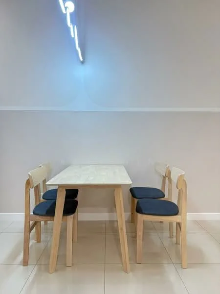 Dining features: light wood dining table, four wooden chairs with blue cushions, white walls, glossy tile flooring, linear pendant light fixture, neutral color scheme; style: modern.