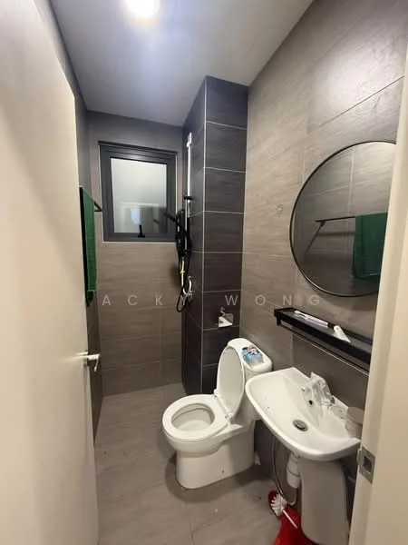 Bathroom features: grey tiled walls, light grey tiled flooring, round mirror, single-sink vanity, white basin, one-piece toilet, shower with glass partition, wall-mounted showerhead, towel rack, green towels, black shelf, window with black frame; style: modern.