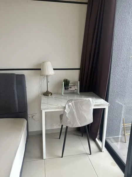 Room features: grey upholstered bed, white marble top desk, black metal legs on desk, transparent acrylic chair, table lamp with white shade, potted plant on desk, floor-to-ceiling windows, brown curtains, white painted walls, glossy tile flooring; style: modern.
