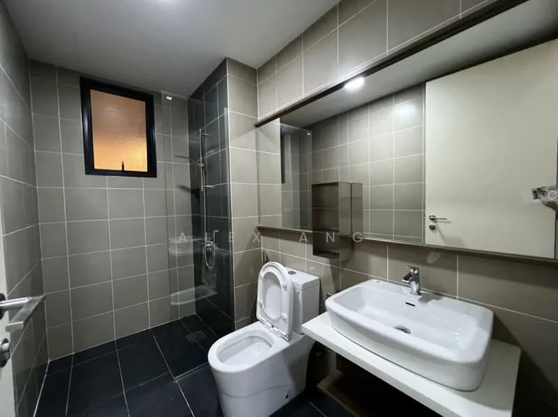 Bathroom features: grey tiled walls, black tile flooring, single-sink vanity with white countertop, chrome basin mixer faucet, framed mirror above vanity, one-piece toilet, glass shower enclosure, shower head, built-in storage cabinet, window for natural light; style: modern.