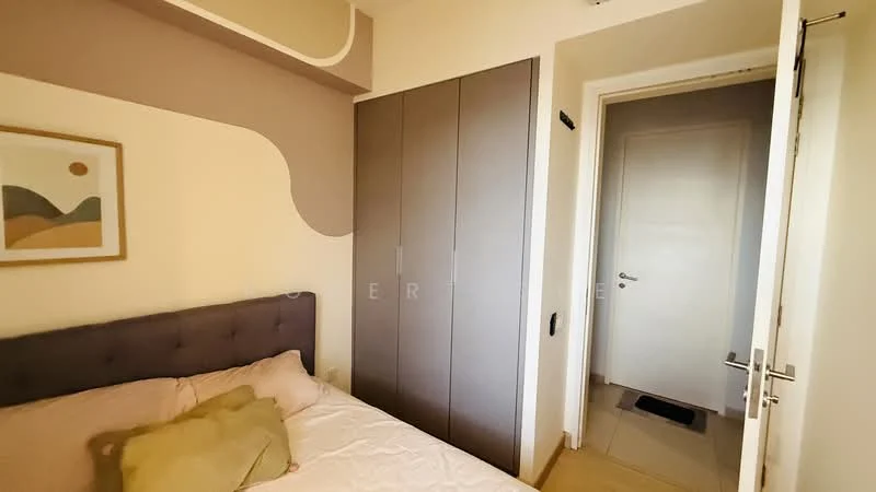 Bedroom features: queen-size bed with upholstered headboard, light-colored bedding, decorative pillows, built-in wardrobe with sliding doors, cream painted walls, neutral-toned accent wall, tile flooring, doorway leading to hallway; style: modern.
