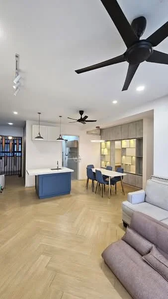 Living features: light wood herringbone flooring, white painted walls, 5-blade ceiling fan in black, recessed LED downlights, pendant lights above dining area, grey fabric sofa, blue kitchen island with seating, dining table with blue upholstered chairs, built-in shelving unit with backlighting, open layout connecting kitchen and dining, large windows for natural light; style: modern.