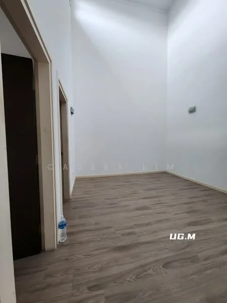 Room features: white painted walls, wooden flooring, high ceiling, doorway, light switch, water bottle on floor.