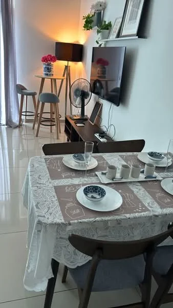 Dining features: dining table with lace tablecloth, 4 dining chairs, ceramic plates, glass drinking glasses, decorative table runner, wall-mounted TV, TV console, floor lamp, fan, decorative flowers, large window with sheer curtains, glossy tiled flooring; style: modern.