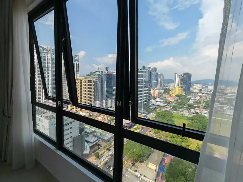 Room features: floor-to-ceiling windows, black window frames, sheer curtains, city view, skyline view, natural light, urban landscape, cloudy sky; style: modern; view: city.