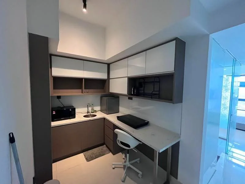 Kitchen features: white upper cabinets, grey lower cabinets, marble countertop, single-bowl stainless-steel sink, chrome pull-down faucet, built-in microwave, black refrigerator, workspace with white desk, white swivel chair, tile flooring, recessed downlights; style: modern.