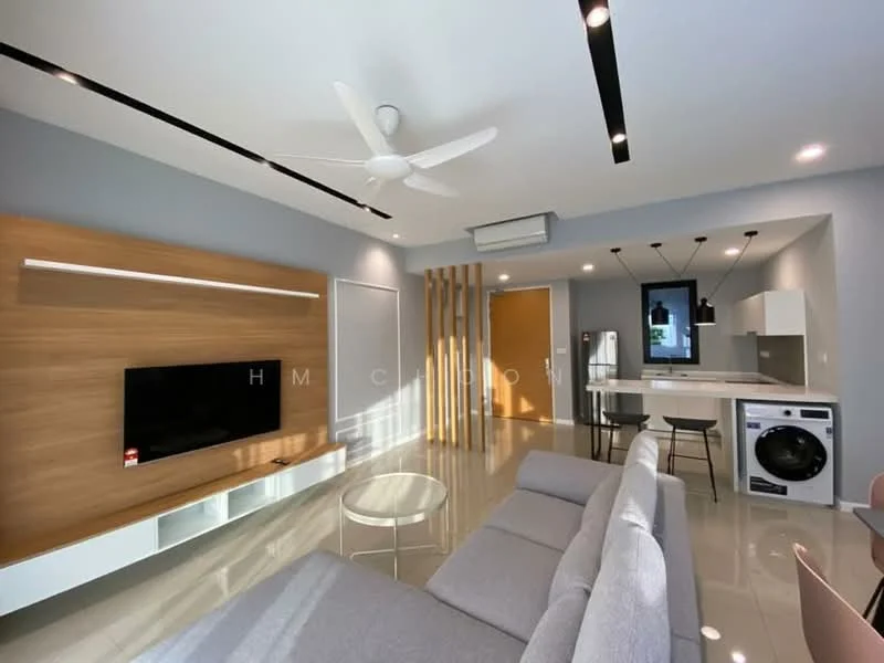 Living features: grey fabric L-shape sectional sofa, round glass coffee table, wall-mounted TV, wood feature wall with integrated lighting, white cabinetry below TV, 5-blade ceiling fan with light, recessed LED downlights, open kitchen area visible, sliding glass door to balcony, washing machine, stainless-steel fridge; style: modern.