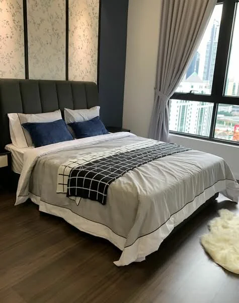 Bedroom features: king-size bed with upholstered headboard, white bedding with black grid pattern, two blue decorative pillows, wooden flooring, floor-to-ceiling windows, grey curtains, wall with floral wallpaper, accent wall in dark blue, nightstand beside bed; style: modern; view: city.