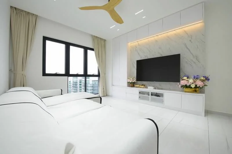 Living features: white walls, marble feature wall with backlighting, large flat-screen TV, white low-profile TV console, 2-seater fabric sofa with black trim, floor-to-ceiling windows, sheer curtains, recessed ceiling lights, 5-blade ceiling fan with light, decorative flower arrangements; style: modern; view: city.