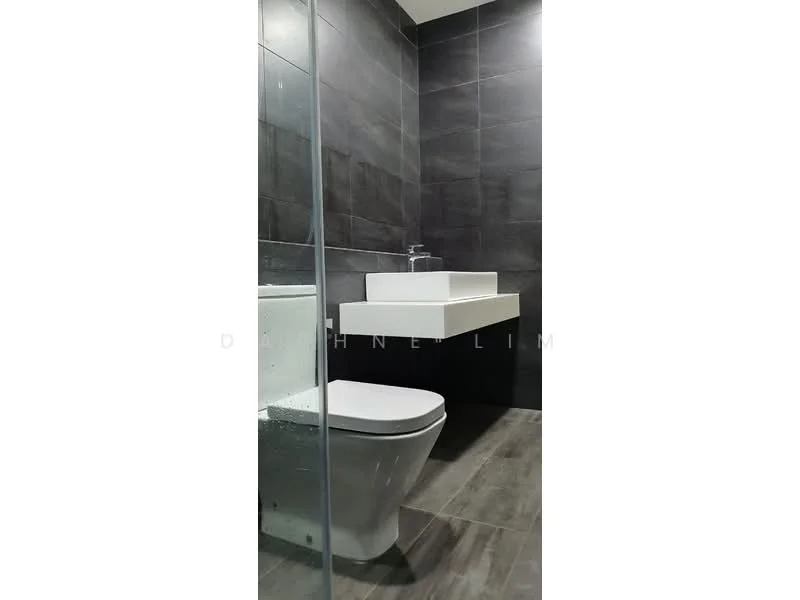 Bathroom features: grey tile walls, dark grey tile flooring, white wall-mounted sink, chrome faucet, one-piece toilet, glass shower enclosure, minimalist design, modern lighting; style: modern.
