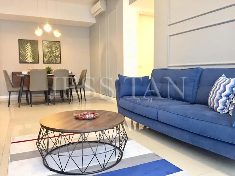 Living features: blue fabric sofa, round coffee table with metal base, area rug with geometric pattern, pendant lighting with three bulbs, wall-mounted air conditioning unit, decorative wall paneling, dining area visible in background, dining table with grey upholstered chairs; style: modern.