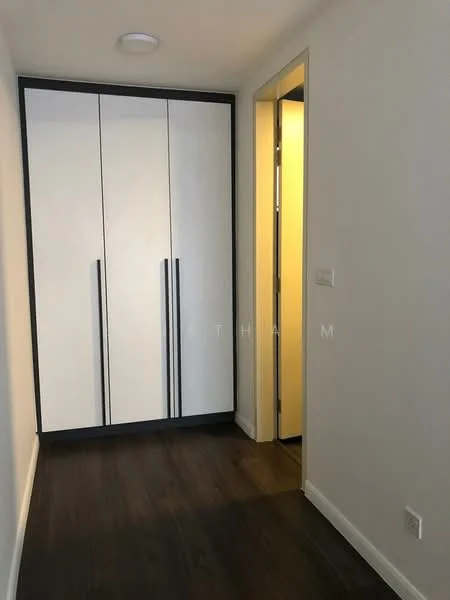Room features: white cabinetry with black handles, wooden flooring, plain white walls, doorway leading to another room, recessed ceiling light; style: modern.