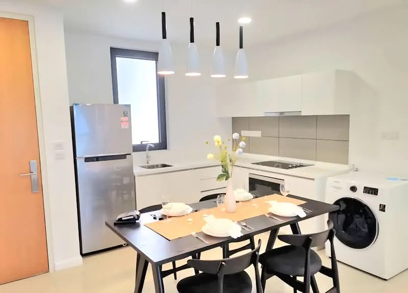 Kitchen features: white cabinetry, grey tiled backsplash, stainless-steel fridge, built-in oven, 4-burner gas hob, single-bowl stainless-steel sink, chrome pull-down faucet, washing machine, pendant lighting, black dining table, black dining chairs, decorative vase with flowers, table setting with plates and glasses; style: modern.