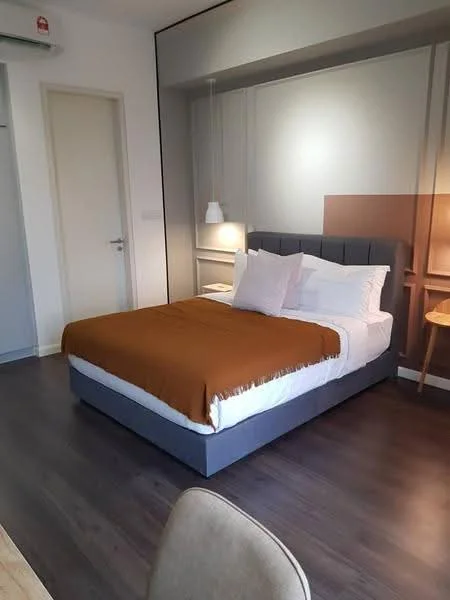 Bedroom features: queen-size bed with brown throw blanket, upholstered headboard, nightstand with lamp, pendant light fixture, wooden flooring, white walls, built-in wardrobe, decorative wall paneling; style: modern.