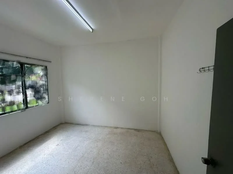 Room features: white painted walls, concrete flooring, single window with metal grille, ceiling light fixture, no visible furniture, empty space; style: minimalist; view: garden.