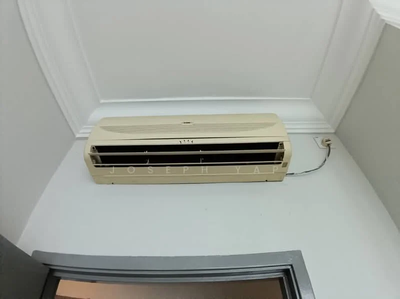 Room features: wall-mounted split AC, white ceiling, crown moulding, grey painted walls, dark door frame.