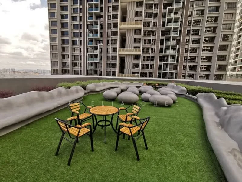 Exterior type: high-rise condominium; features: landscaped garden with artificial grass, outdoor seating area with wooden table and chairs, decorative stone features, surrounding high-rise buildings, open sky view; style: modern.