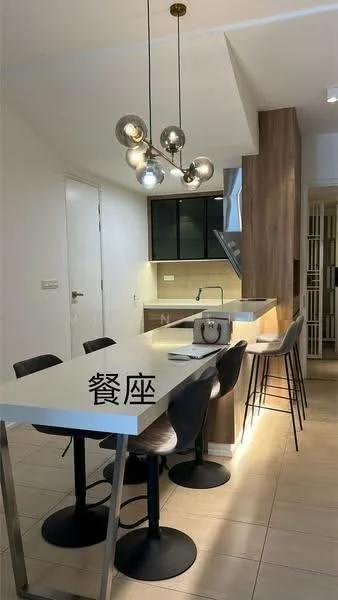 Kitchen features: white countertop, black cabinetry, wood paneling, stainless-steel range hood, built-in oven, 4-burner gas hob, pendant lighting with metallic finish, bar stools, tile flooring, recessed lighting; style: modern.