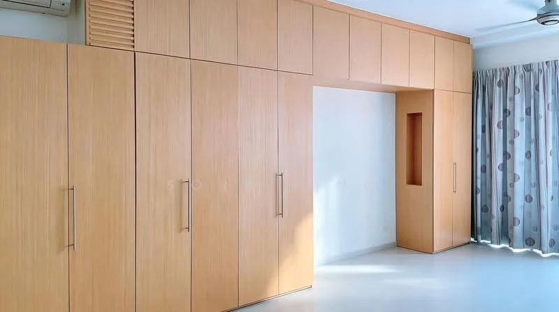 Room features: built-in cabinets with wood finish, light wood cabinetry, floor-to-ceiling storage, white walls, large window with sheer curtains, grey patterned curtains, smooth flooring, air conditioning unit; style: modern.