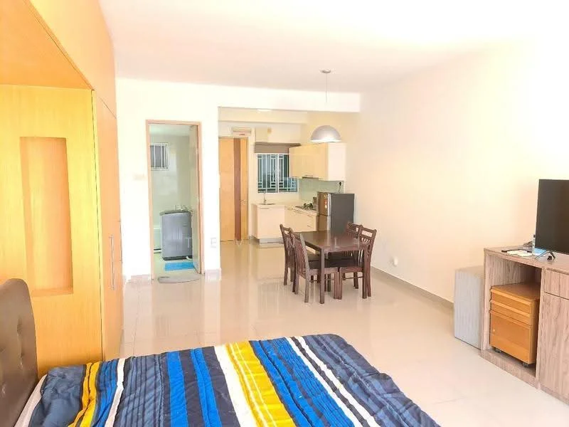 Living features: queen-size bed with upholstered headboard, striped bedding in blue, yellow, and white, wooden wardrobe with sliding doors, TV console with flat-screen TV, wooden dining table with four chairs, pendant light fixture, large window with natural light, glossy tile flooring, neutral painted walls, open layout connecting to kitchen area; style: modern. Kitchen features: kitchen counter with bar stools, stainless-steel sink, built-in cabinets, kitchen appliances visible, open layout connecting to living area; style: modern.