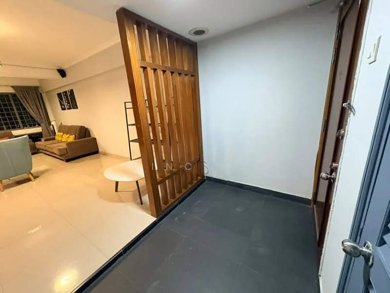Room features: wooden slatted partition, grey tiled flooring, white painted walls, door with metallic handle, light fixture on ceiling, corner with no visible furniture, open space leading to living area; style: modern.