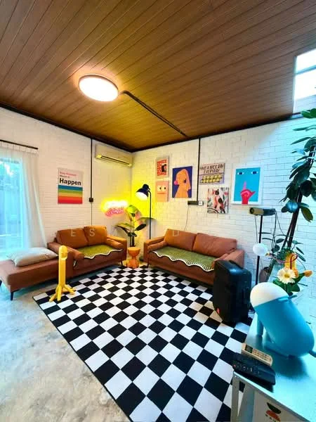 Living features: two 3-seater fabric sofas in orange, black and white checkered area rug, wooden ceiling, white painted walls with exposed brick, floor-to-ceiling window with sheer curtains, wall-mounted air conditioning unit, decorative wall art, standing lamp with yellow shade, potted plant, small side table, black speaker, blue decorative object; style: modern.