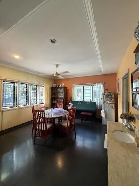 Dining features: round dining table, 6 dining chairs, ceiling fan, wall-mounted cabinet, cream painted walls, orange accent wall, black polished flooring, windows with grills, refrigerator, sink with countertop, decorative items on shelves; style: traditional. Living features: sofa, coffee table, decorative wall art, windows with curtains; style: traditional.