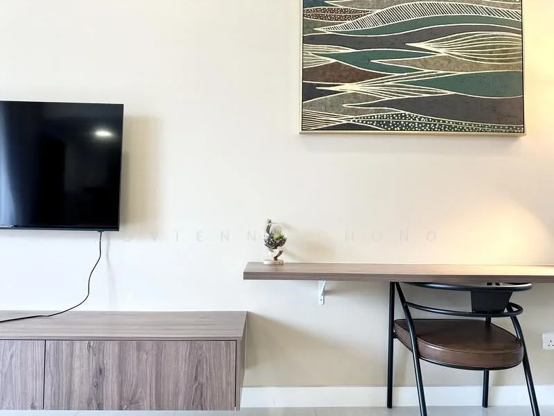 Living features: wall-mounted TV, wooden TV console, wooden desk, black chair, decorative artwork on wall, light-colored painted walls, natural light from window, minimalist decor; style: modern.