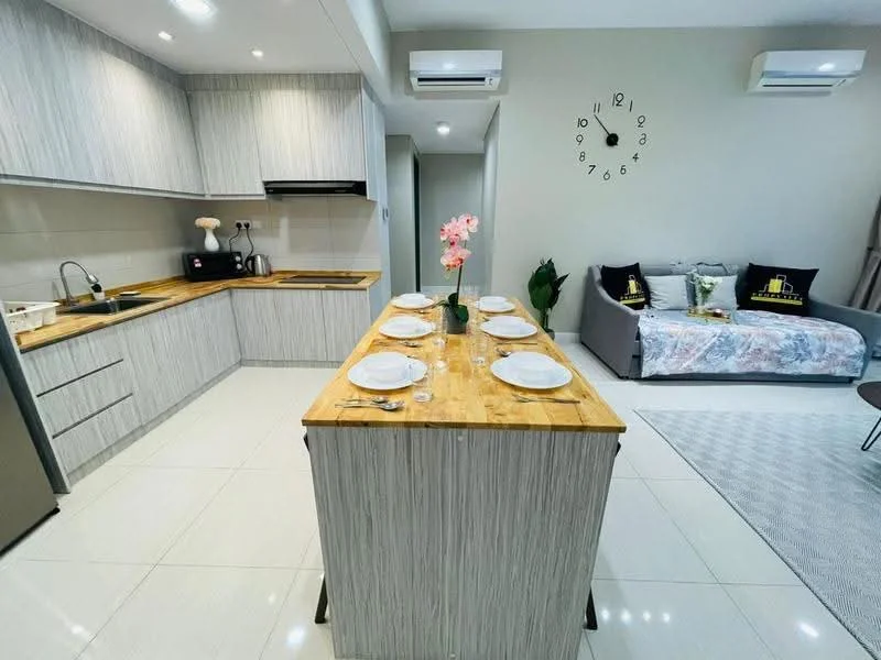Kitchen features: light wood cabinetry, stainless-steel sink, chrome pull-down faucet, wood countertop on island, built-in oven, stainless-steel fridge, ceramic tile flooring, recessed downlights, 2 wall-mounted split ACs, open shelving, decorative plant, dining table with 6 plates, grey sofa, wall clock; style: modern.