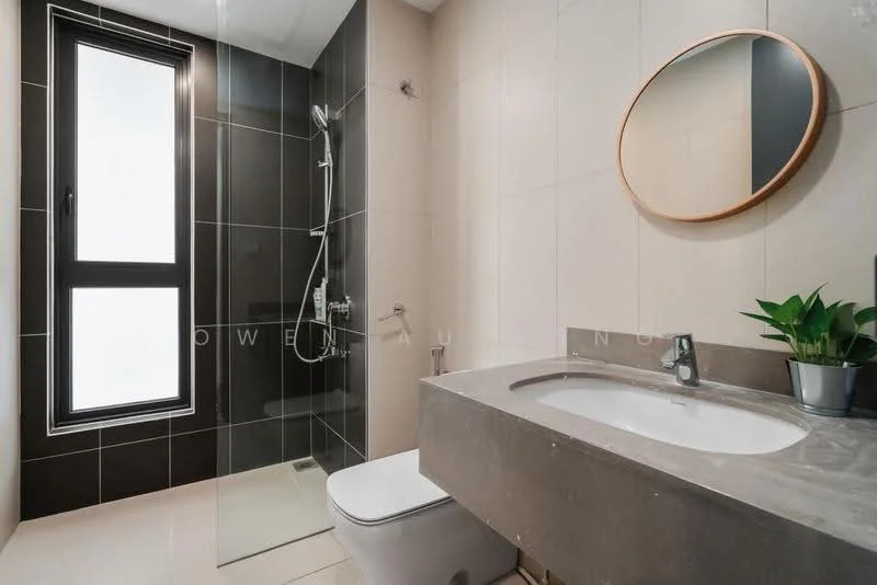 Bathroom features: walk-in shower with glass enclosure, chrome handheld shower, wall-mounted faucet, single-sink vanity with stone countertop, round mirror, one-piece toilet, grey tiled walls, cream tiled flooring, plant in ceramic pot, floor-to-ceiling window; style: modern.