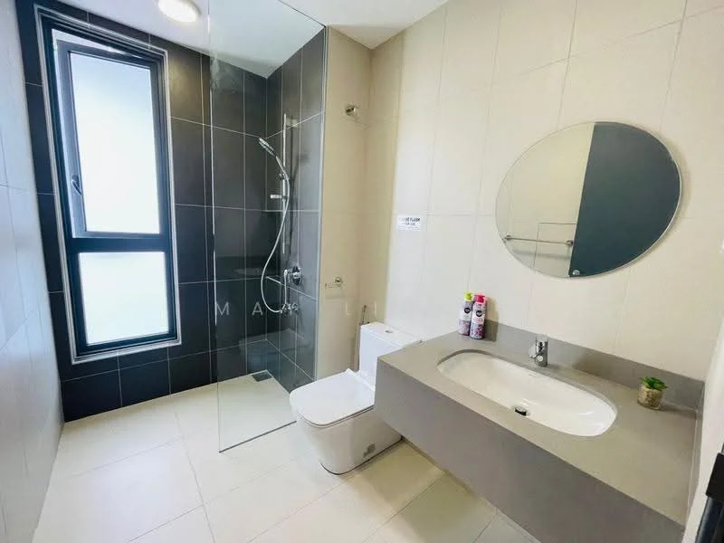 Bathroom features: walk-in shower with glass enclosure, rain shower head, handheld shower, single-sink vanity with grey countertop, round mirror, one-piece toilet, grey tiled walls, light-colored floor tiles, window for natural light; style: modern.