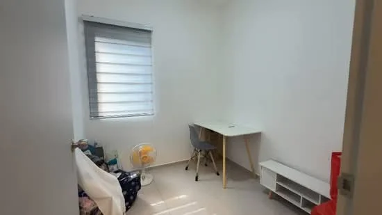 Room features: white painted walls, tile flooring, window with blinds, desk with white surface, grey chair, small fan, shelving unit, storage bags, natural light from window; style: modern.