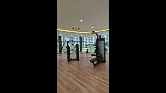 Room features: wooden flooring, large windows, natural light, fitness equipment, multi-gym machine, free weights, recessed lighting, crown moulding, green view outside; style: modern; view: garden.