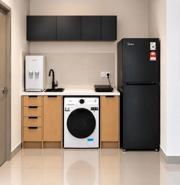 Kitchen features: black cabinetry, white countertop, stainless-steel sink, black gooseneck faucet, built-in refrigerator, freestanding washing machine, induction cooktop, tile backsplash, ceramic tile flooring, wall-mounted cabinets, two-door refrigerator, kitchen appliances, under-cabinet lighting; style: modern.