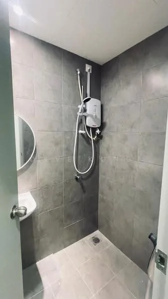 Bathroom features: grey tiled walls, grey tiled flooring, round mirror, shower with glass enclosure, wall-mounted shower head, handheld shower, toilet, water heater, chrome faucet, drain in floor; style: modern.