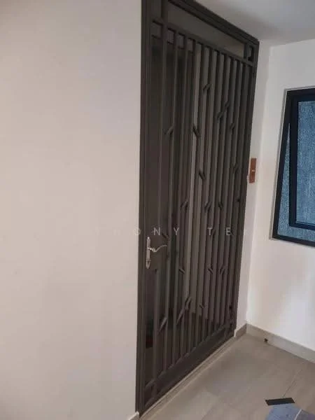 Room features: metal security door with vertical bars, white painted walls, grey tiled flooring, window with black frame, light switch, door handle; style: modern.