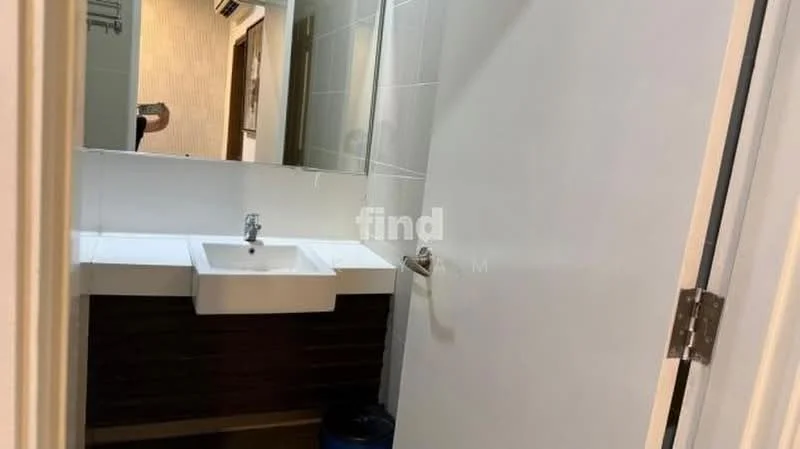 Bathroom features: white ceramic sink, chrome basin mixer faucet, mirror above sink, wood cabinetry below sink, white tiled walls, grey tiled flooring, toilet visible in mirror, towel rack, wall-mounted air conditioning unit; style: modern.