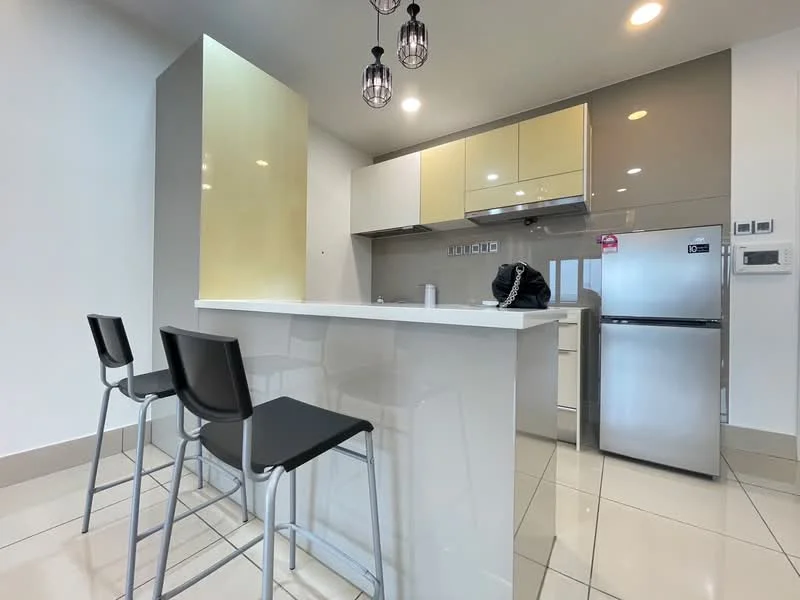 Kitchen features: white glossy cabinetry, gold accent cabinetry, stainless-steel range hood, built-in oven, stainless-steel fridge, white quartz countertop, bar seating with two black stools, ceramic tile flooring, recessed downlights, pendant lights, grey backsplash; style: modern.
