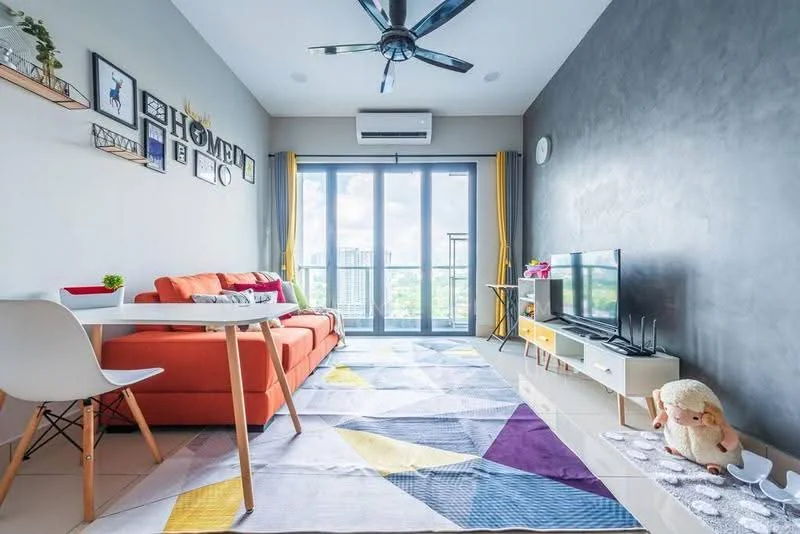Living features: orange fabric sofa, white coffee table, TV console, wall-mounted TV, area rug with geometric pattern, 5-blade ceiling fan, floor-to-ceiling windows, curtains in yellow, decorative wall art, shelves with decorative items, light grey accent wall, white tiled flooring, air conditioning unit; style: modern; view: city.